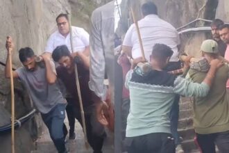 Tourists pay local porters to carry them up 10,000 steps