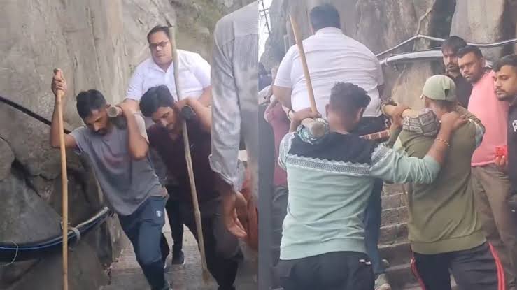 Tourists pay local porters to carry them up 10,000 steps