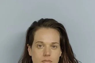 Woman accused of killing missing father found in shallow grave remains on the run, police say