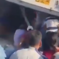 A woman was injured while people were stealing cargo from an overturned truck