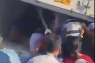 A woman was injured while people were stealing cargo from an overturned truck