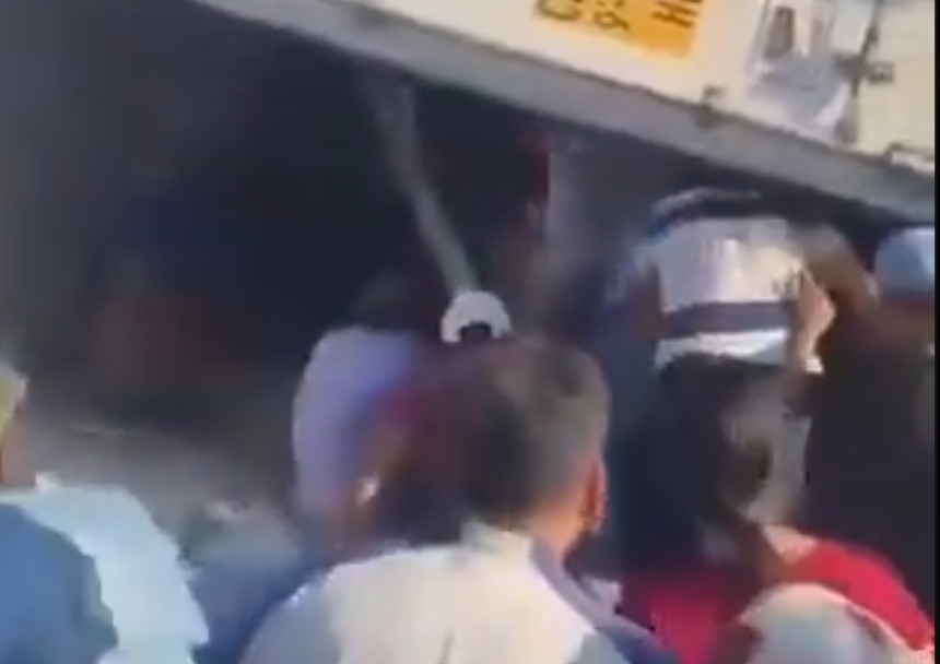 A woman was injured while people were stealing cargo from an overturned truck
