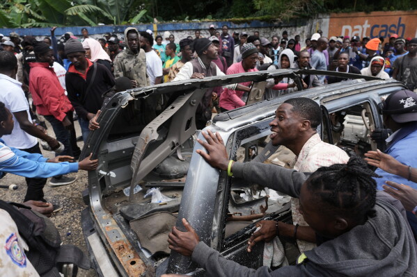 Gang displays high-caliber weapons after deadly attack in Haiti and threatens to kill hostages