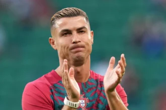 Cristiano Ronaldo jumps security barrier to take photos with two young fans