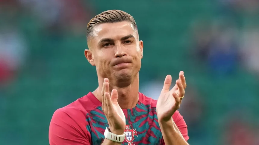 Cristiano Ronaldo jumps security barrier to take photos with two young fans